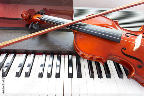 Violin on piano keyboard. Music instrument. Art and music background.