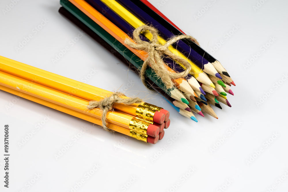Obraz premium Colored pencil crayons on white isolated ground. School accessories on a white table.