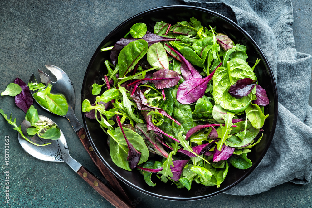 Fresh salad mix of baby spinach, arugula leaves, basil, chard and lambs lettuce. Salad bowl, healthy food, top view Fresh salad mix of baby spinach, arugula leaves, basil, chard and lambs lettuce. Salad bowl, healthy food, top view