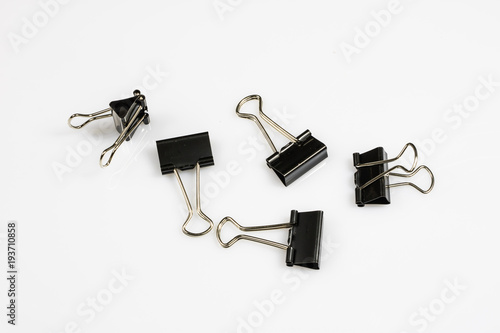 Colorful office paper clips isolated on white ground. Office accessories on a white table.