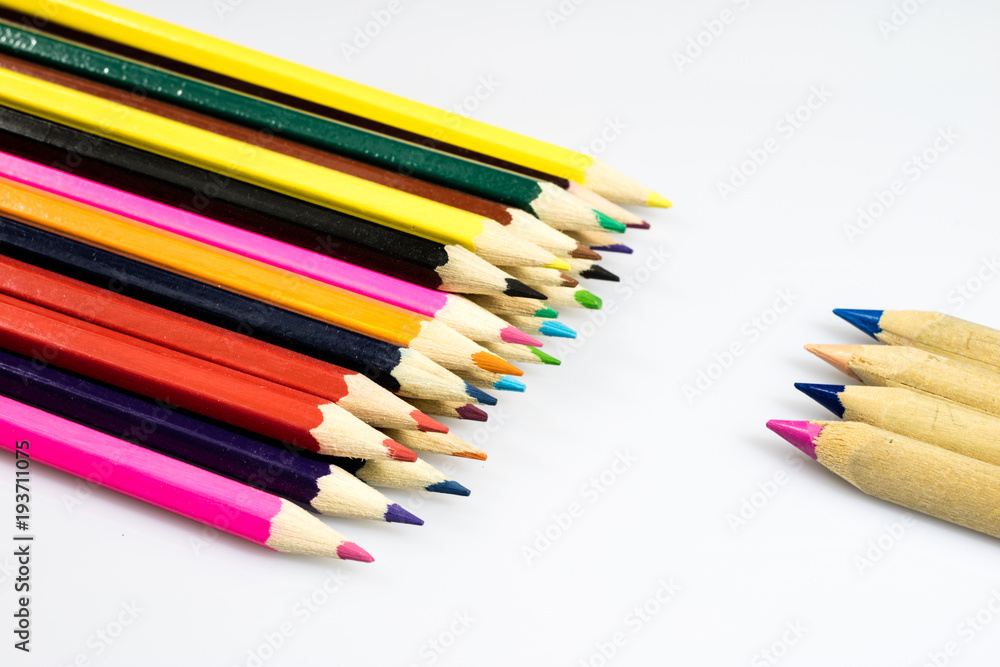 Colored pencil crayons on white isolated ground. School accessories on a white table. Colored pencil crayons on white isolated ground. School accessories on a white table.