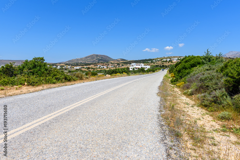 Asphalt road on beautiful Naxos island in summer day . Cyclades, Greece