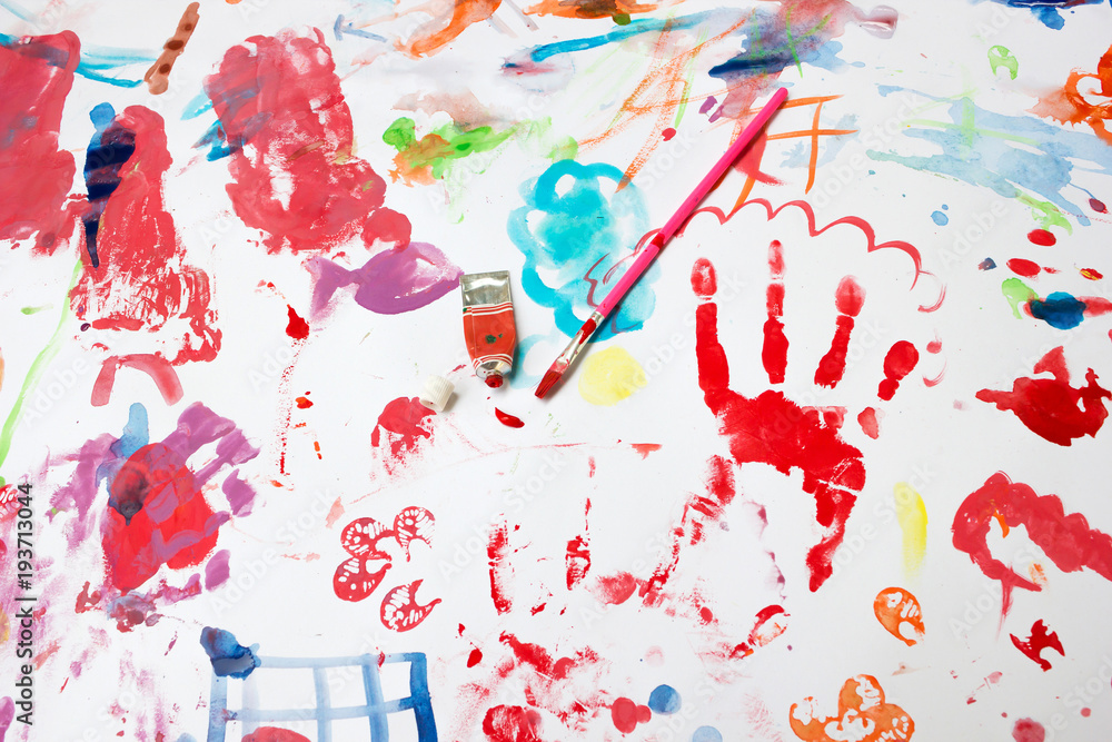 Naklejka premium Child's painting in a white paper with water colors and brush (equipment of painting) .