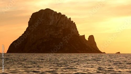 The sunset on the island of Es vedra, Ibiza photo