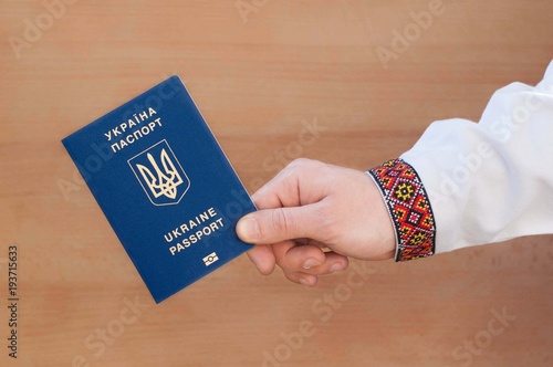 Ukrainian passport on the wooden background.