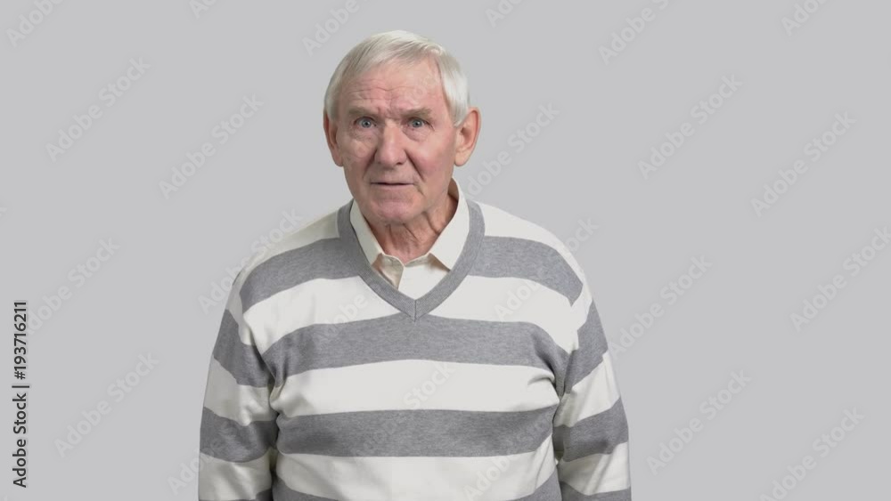 Frustrated aged man on grey background. Angry senior person arguing and gesturing with index finger. Pensioner fight for his rights. Frustrated aged man on grey background. Angry senior person arguing and gesturing with index finger. Pensioner fight for his rights.