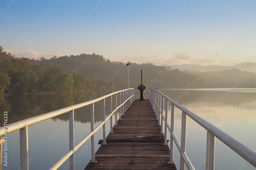 bridge on lake with mountain background in morning. countryside place in asian.