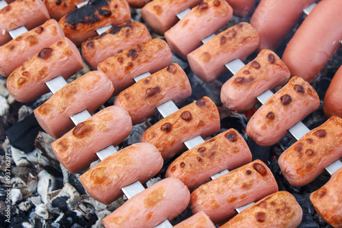 Roasting sausages on the fire, close-up view