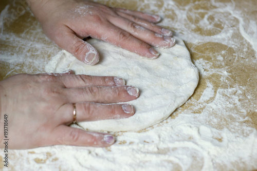 Housewife making the dough for dumplings