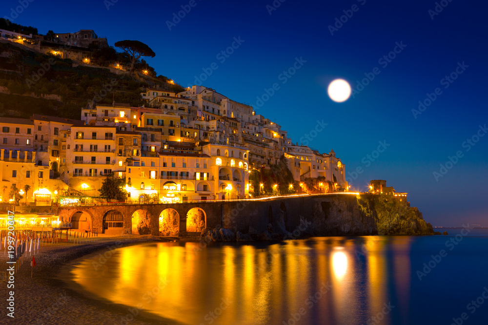 Night view of Amalfi cityscape on coast line of mediterranean sea, Italy
