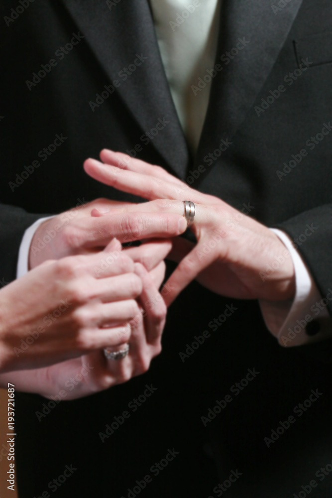 Fototapeta premium Groom puts on Wedding Ring, Shallow depth of Field