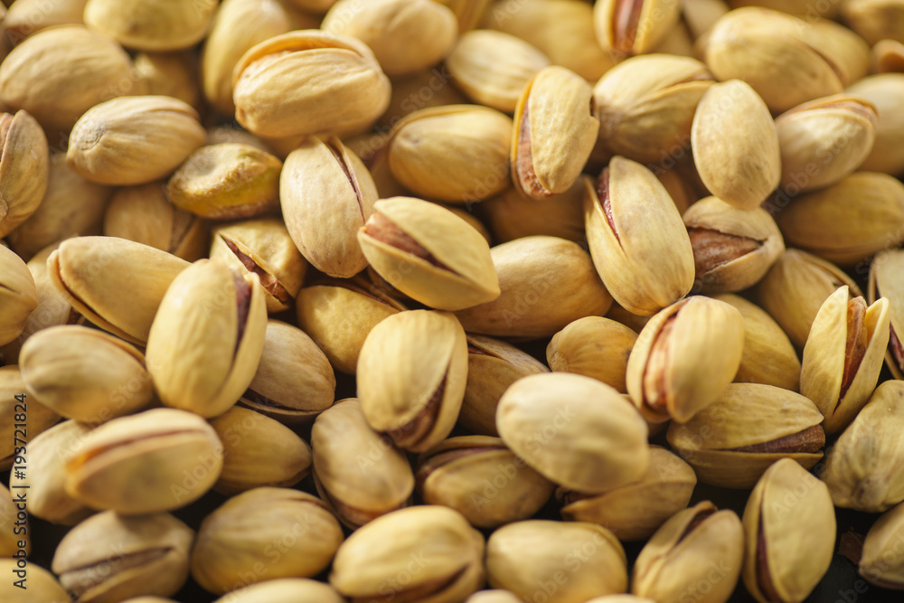 Pistachio nuts. A close-up photograph. Unrefined whole kernel Pistachio nuts. A close-up photograph. Unrefined whole kernel
