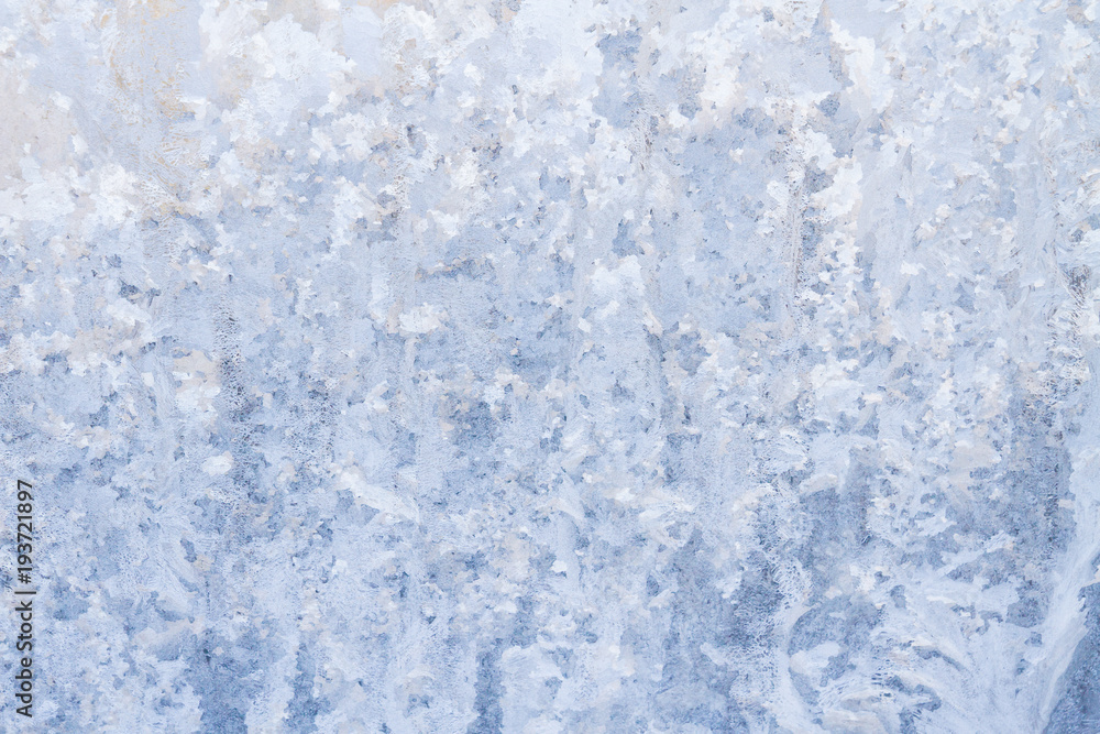 Winter frosty patterns on the frozen ice window