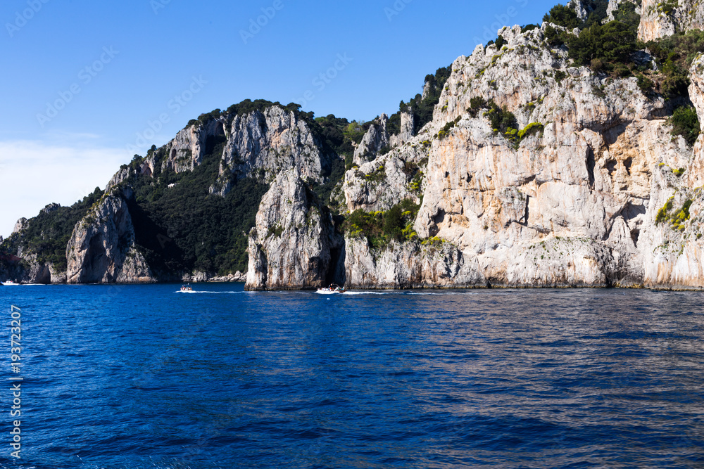 Magnificent rocks and cliffs against the background of the sea and the blue sky - natural and travel background