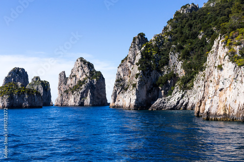 Magnificent rocks and cliffs against the background of the sea and the blue sky - natural and travel background © Ирина Селина