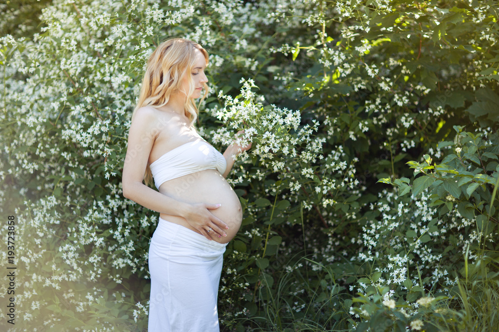 Beautiful pregnant blond woman in the park. Beautiful pregnant blond woman in the park.