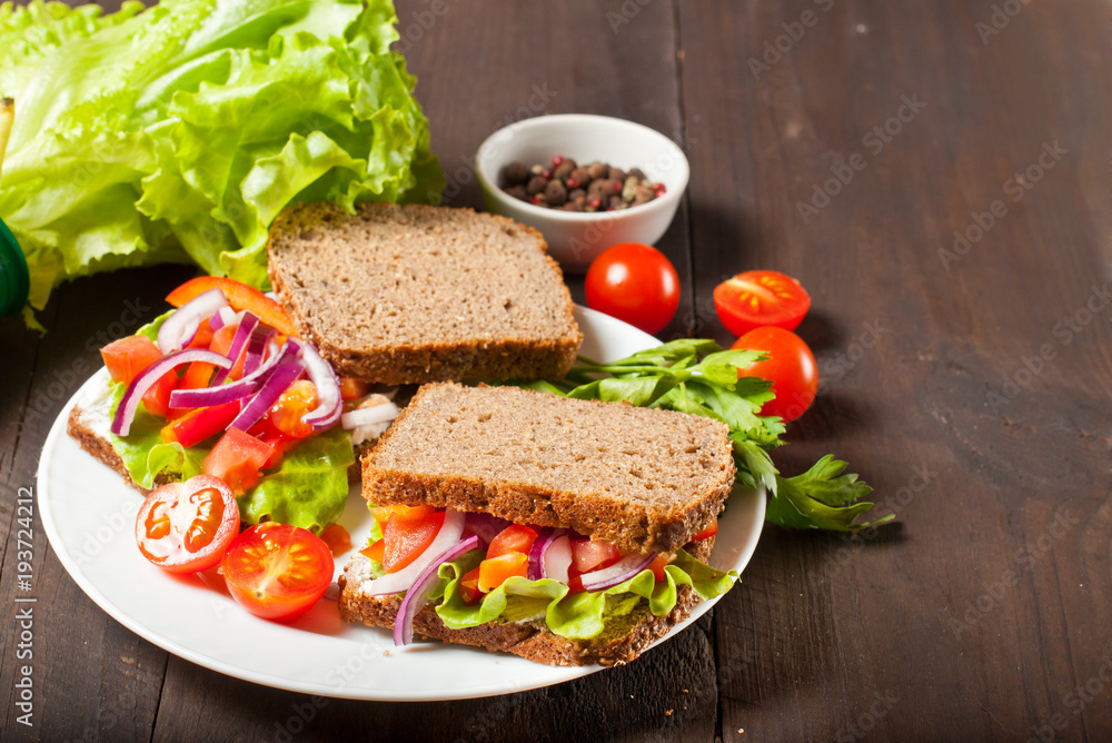 Vegan burger or sandwiches with rye bread, different vegetables and sprouts. Concept of healthy eating or vegetarian food. Vegan burger or sandwiches with rye bread, different vegetables and sprouts. Concept of healthy eating or vegetarian food.