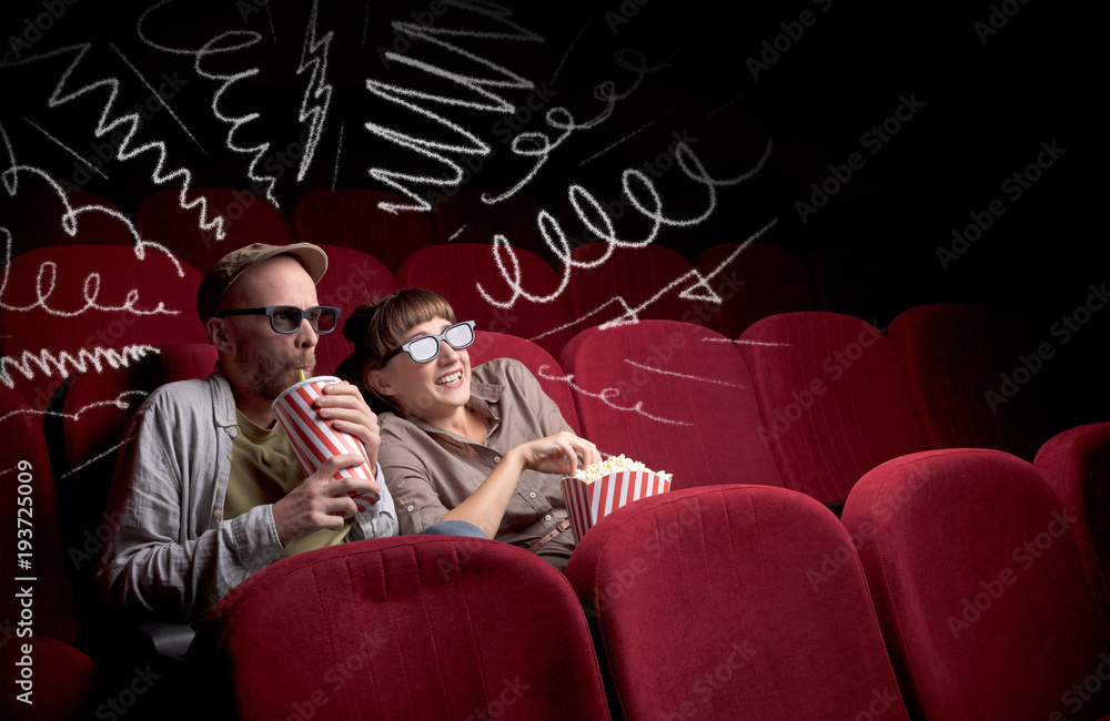 Naklejka premium Cute couple in cinema watching movie