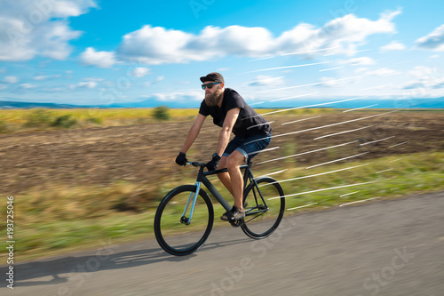 Casual cyclist riding bicycle very fast