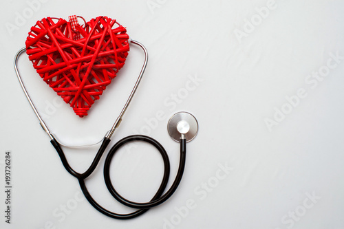 Medicine. Pressure sensor, heart shape, stethoscope and dollars on a wooden background, copyspace