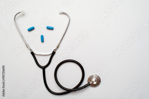 Medicine. Pressure sensor, heart shape, stethoscope and dollars on a wooden background, copyspace