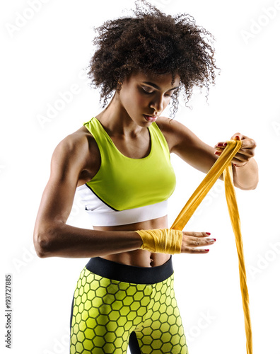 Boxer strapping up hands. Photo of sporty african girl preparing her gloves for a fight in silhouette on white background. Fitness and healthy lifestyle concept