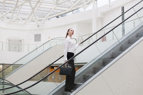 Medzhasova-Juliya. Business suit, handbag, escalator +