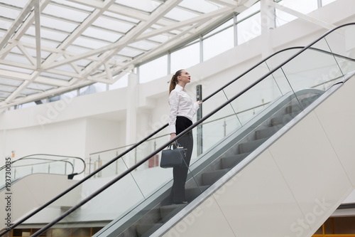 Medzhasova-Juliya. Business suit, handbag, escalator +