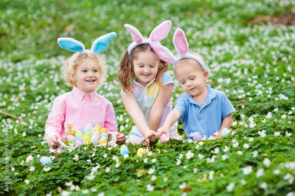 Kids with bunny ears on Easter egg hunt. Kids with bunny ears on Easter egg hunt.