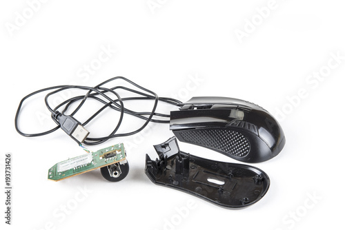 Dismantled computer mouse with USB cable on the white