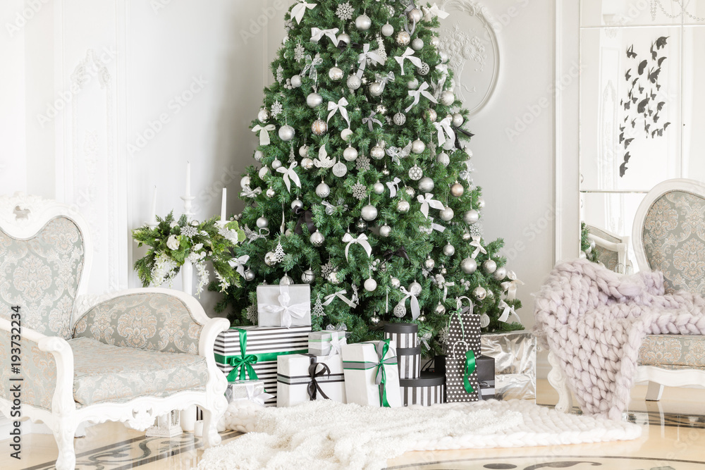 classic apartments with a white fireplace, decorated tree, bright sofa, large windows. Christmas morning. classic apartments with a white fireplace, decorated tree, bright sofa, large windows. Christmas morning.