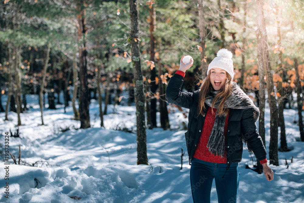 Fototapeta premium portrait Young pretty woman enjoying and playing with snow in winter