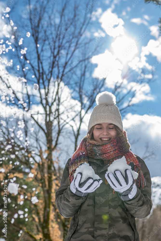 portrait Young pretty woman enjoying and playing with snow in winter portrait Young pretty woman enjoying and playing with snow in winter