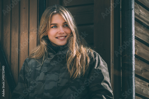 portrait Young pretty woman in winter in a log cabin in the snow