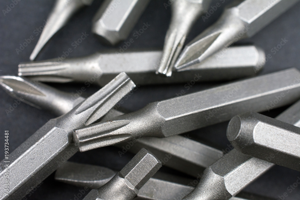 Fototapeta premium Set of heads for screwdriver (bits) Tools collection copy space, close up, selective focus. dark background