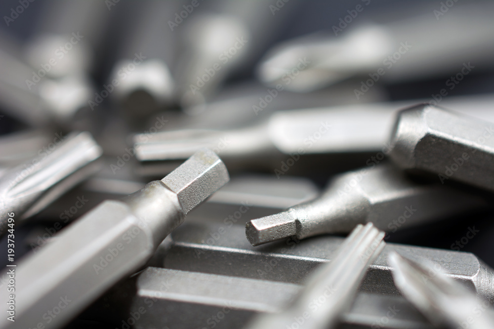 Set of heads for screwdriver (bits) Tools collection copy space, close up, selective focus. dark background Set of heads for screwdriver (bits) Tools collection copy space, close up, selective focus. dark background