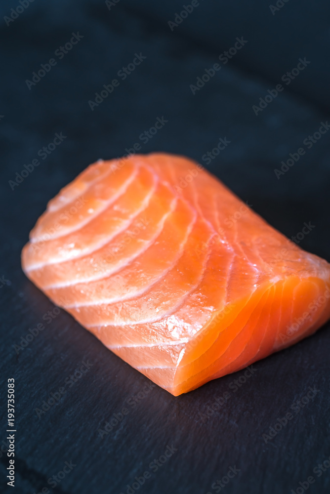 Salmon on the black stone board Salmon on the black stone board