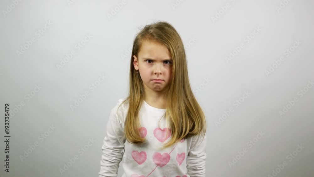 The young girl looking angry and begins to cry. A frustrated child crying looking straight The young girl looking angry and begins to cry. A frustrated child crying looking straight