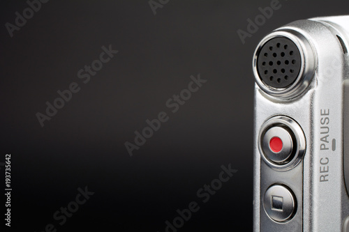 dictaphone closeup of a red record button selective focus dark blurred background wiretapping concept copy space