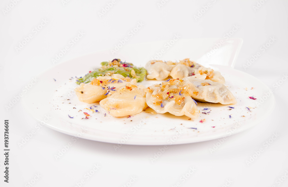 Dumplings with different kinds of stuffing decorated on a plate Dumplings with different kinds of stuffing decorated on a plate