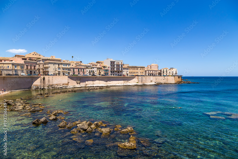 Syracuse, Italy. Picturesque old quay on the island of Ortygia, bathing in clear waters