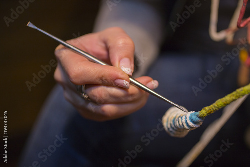 The hand of the artist. Work with a sharp tool. The execution of the decorative sculpture.