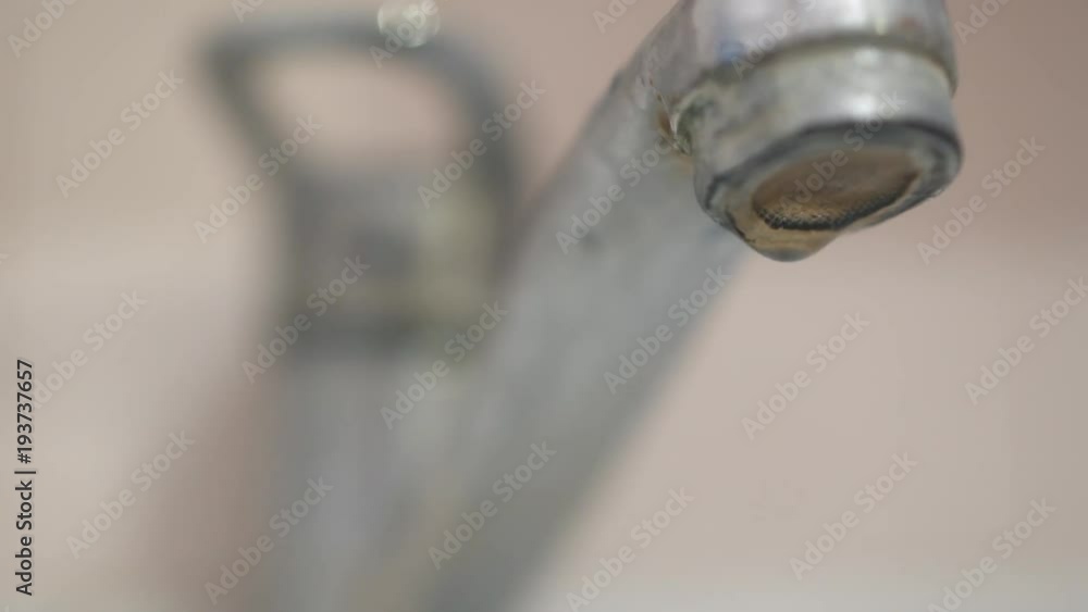 Rusty faucet flows. Concept of waste of water resources. Drops flow slowly. Slow Motion Rusty faucet flows. Concept of waste of water resources. Drops flow slowly. Slow Motion
