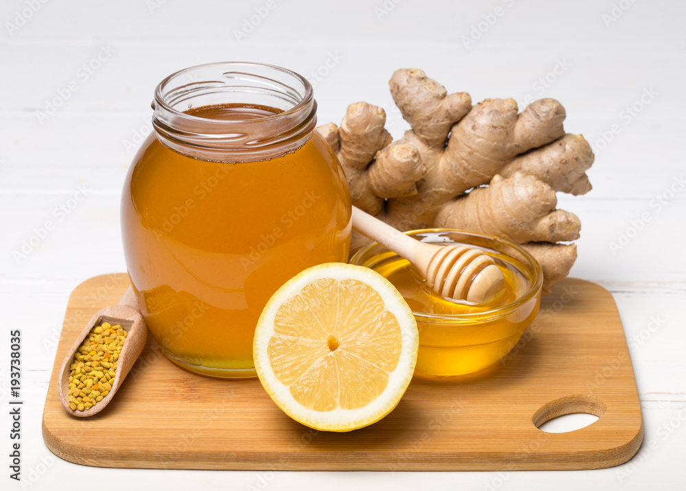 Honey in jar with honey dipper on wooden background Honey in jar with honey dipper on wooden background