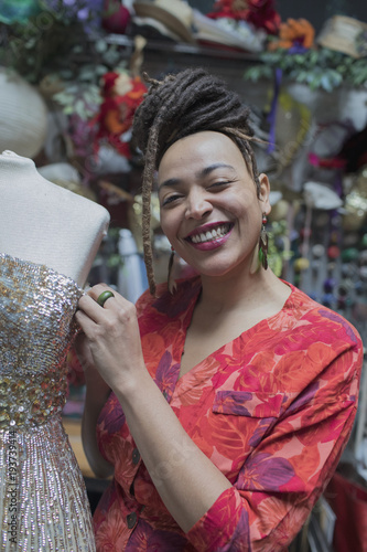 Portrait of smiling young female designer working at studio
