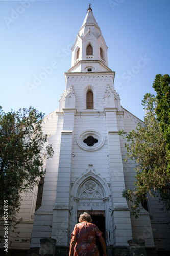 Old woman entering the church.