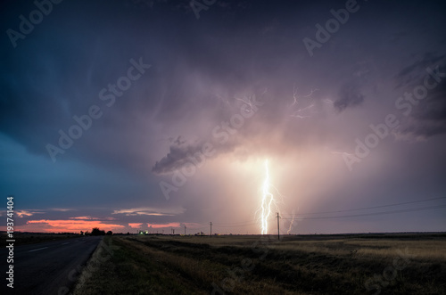 Dusk colors of the storm with lightning.