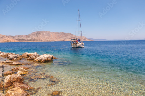 A single yacht moored to the shore