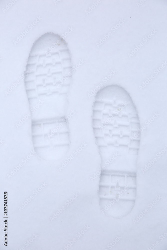 Footprints of shoes on fresh snow.