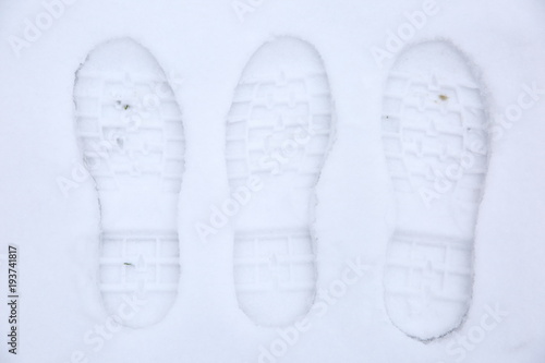 Footprints of shoes on fresh snow.